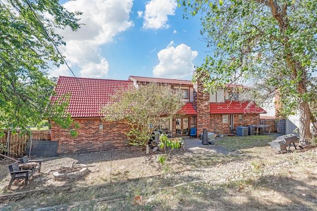 back of property featuring central AC