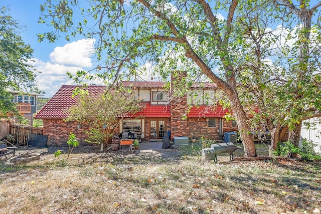 back of property with a patio area and cooling unit