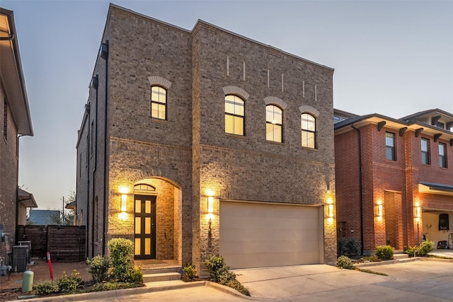 townhome / multi-family property featuring french doors, concrete driveway, and a garage