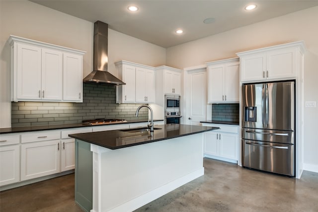 kitchen with sink, white cabinets, wall chimney range hood, and appliances with stainless steel finishes