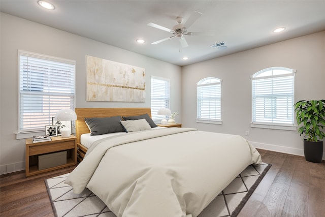 bedroom with ceiling fan and dark wood-type flooring