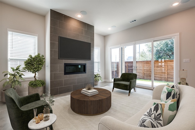 living room with a tiled fireplace