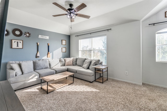 living room featuring ceiling fan, carpet flooring, a wealth of natural light, and vaulted ceiling