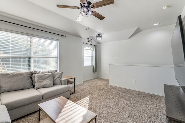 carpeted living room featuring ceiling fan and vaulted ceiling