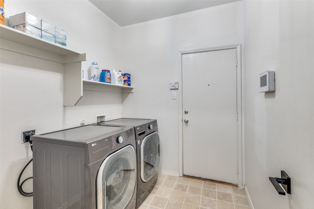 clothes washing area with washing machine and clothes dryer