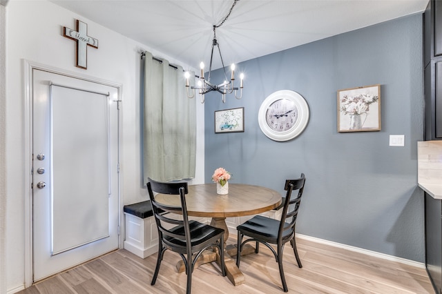 dining area featuring light hardwood / wood-style floors and a notable chandelier