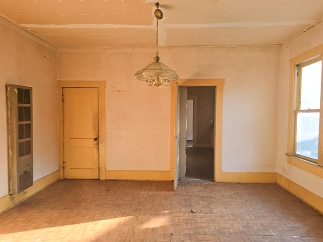 unfurnished room with an inviting chandelier