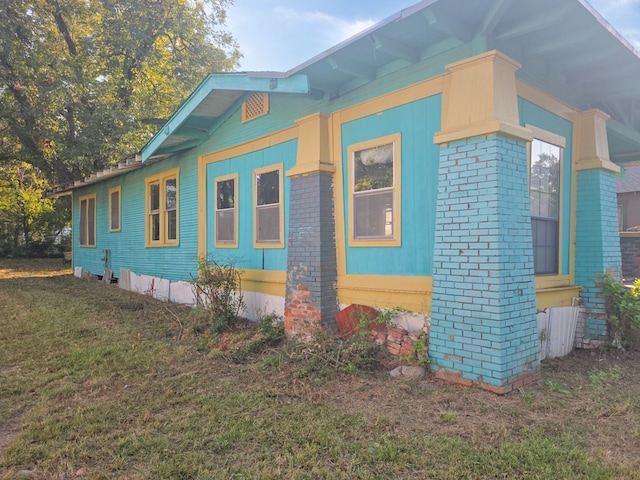 view of property exterior with a yard