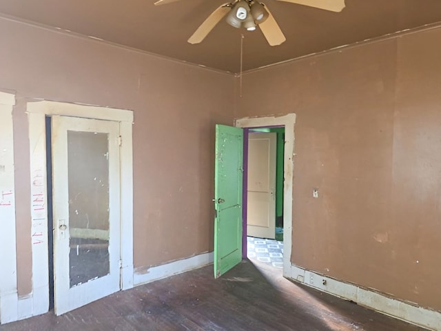 empty room with ceiling fan and dark hardwood / wood-style flooring