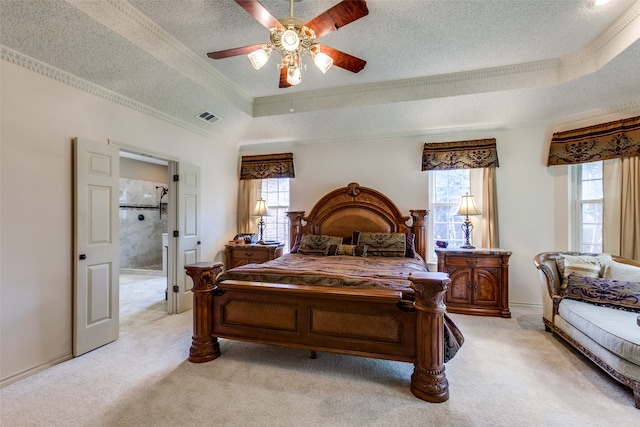 carpeted bedroom featuring connected bathroom, a textured ceiling, multiple windows, and ceiling fan