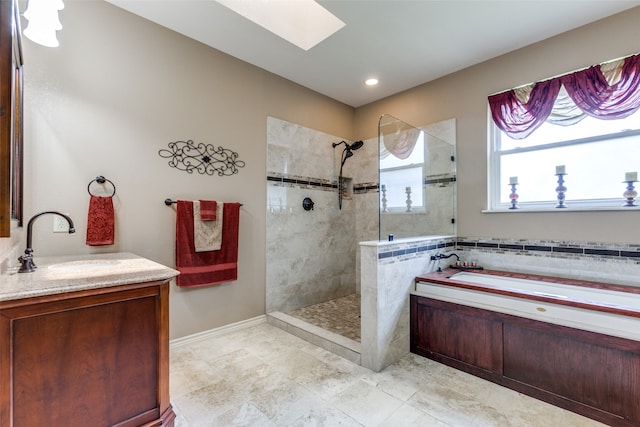 bathroom featuring vanity, shower with separate bathtub, tile patterned floors, and a skylight