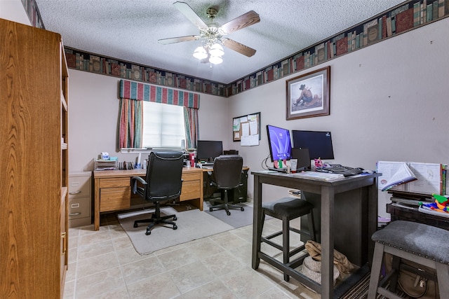 office area with a textured ceiling and ceiling fan