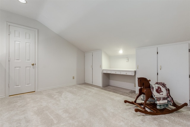 additional living space with lofted ceiling and light colored carpet