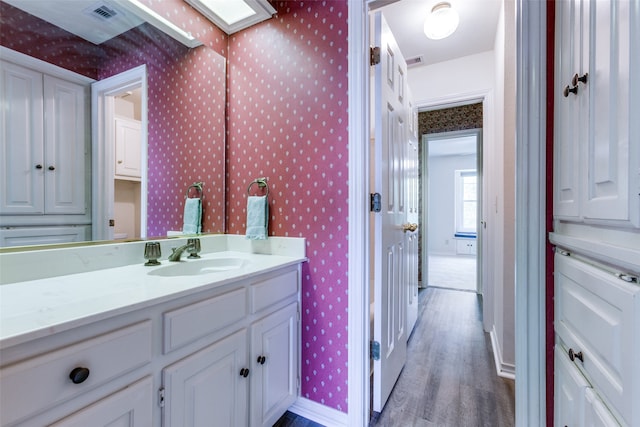 bathroom featuring vanity and hardwood / wood-style floors