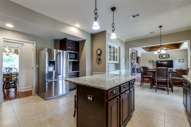 kitchen with stainless steel appliances, dark brown cabinets, a center island, and hanging light fixtures