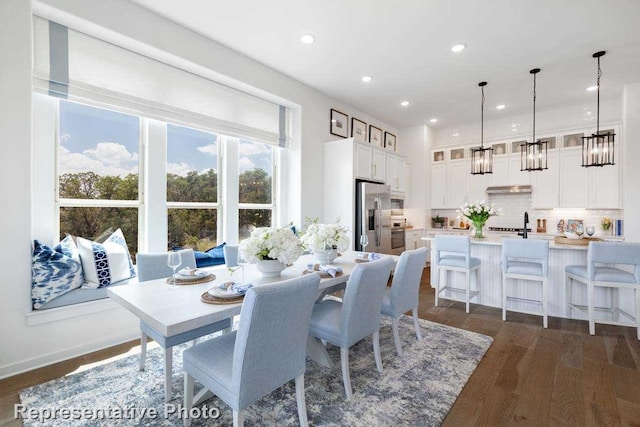 dining area with dark hardwood / wood-style flooring