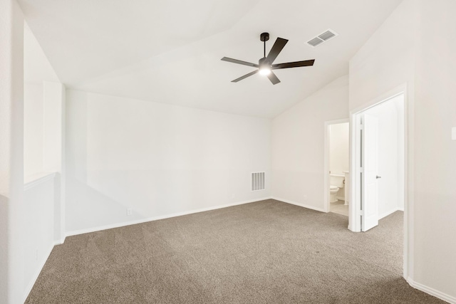 unfurnished bedroom featuring baseboards, carpet, vaulted ceiling, and visible vents