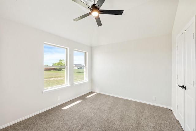 spare room with carpet floors, baseboards, a ceiling fan, and high vaulted ceiling