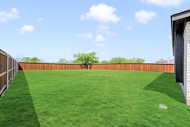 view of yard with a fenced backyard