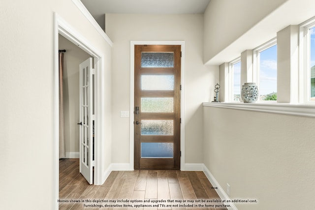 foyer entrance with light hardwood / wood-style flooring