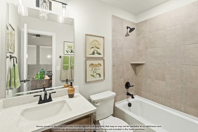 full bathroom featuring vanity, tiled shower / bath combo, toilet, and ceiling fan