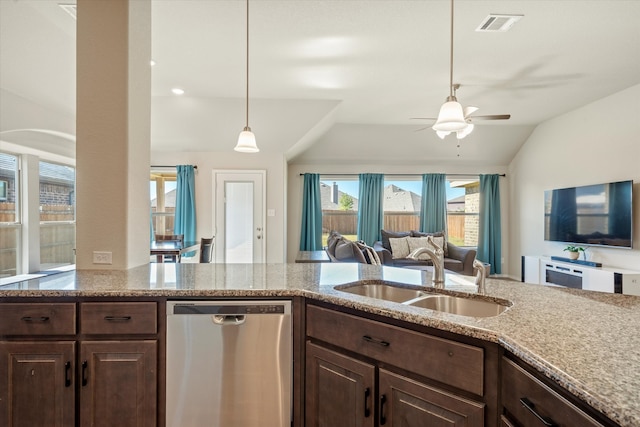 kitchen with dark brown cabinetry, dishwasher, vaulted ceiling, and sink