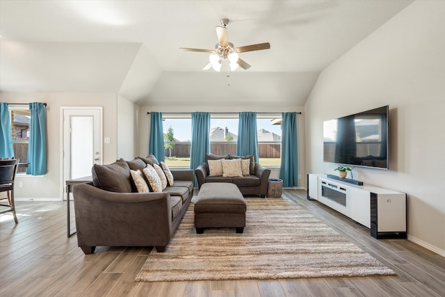 living room with ceiling fan, wood-type flooring, and lofted ceiling