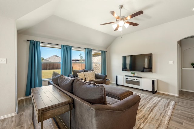 living room with lofted ceiling, ceiling fan, and wood-type flooring