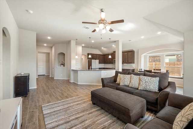 living room featuring light hardwood / wood-style flooring and ceiling fan