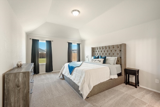 carpeted bedroom featuring vaulted ceiling