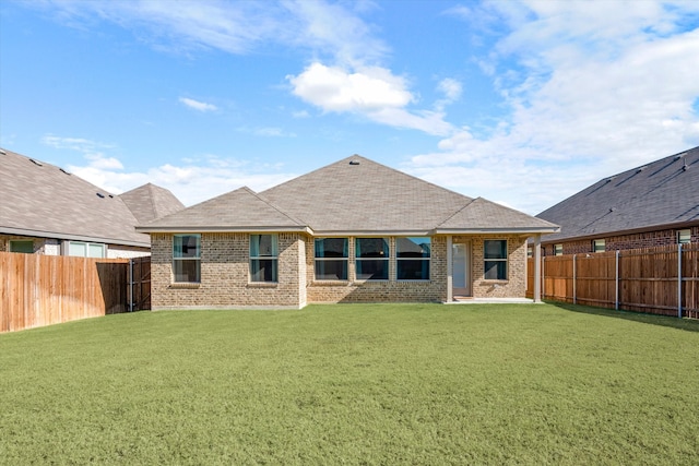 rear view of property with a lawn