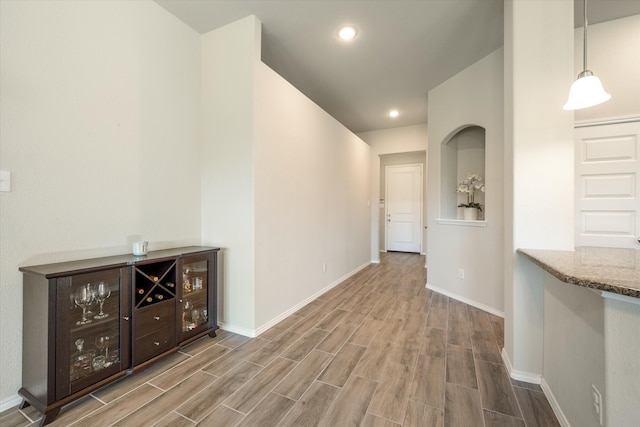 corridor with wood-type flooring