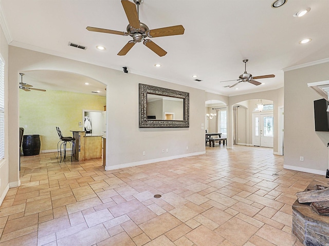 living room with ceiling fan with notable chandelier and crown molding