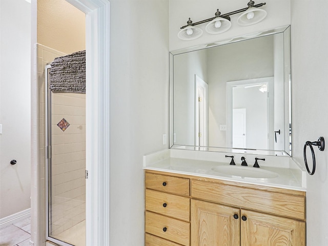 bathroom with tile patterned flooring, vanity, and an enclosed shower