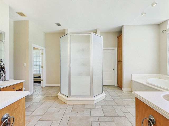 bathroom with tile patterned floors, vanity, and plus walk in shower