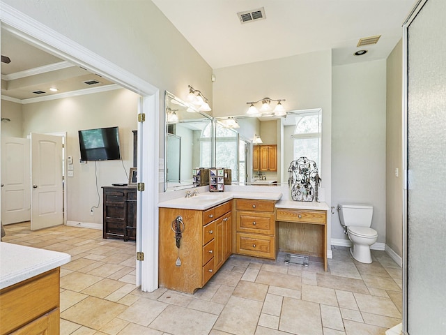 bathroom with tile patterned flooring, vanity, toilet, and crown molding