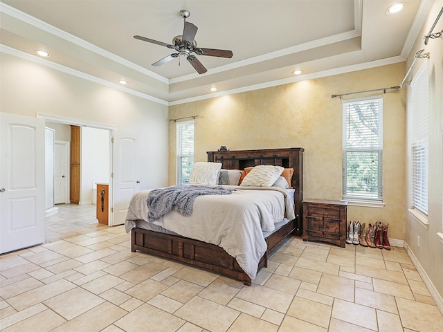 bedroom with a raised ceiling, ceiling fan, and ornamental molding