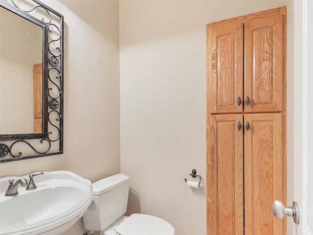 bathroom with toilet and sink