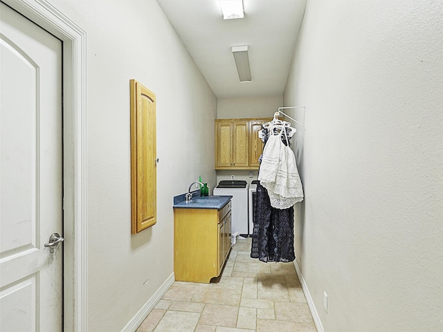 laundry room featuring cabinets and washing machine and clothes dryer