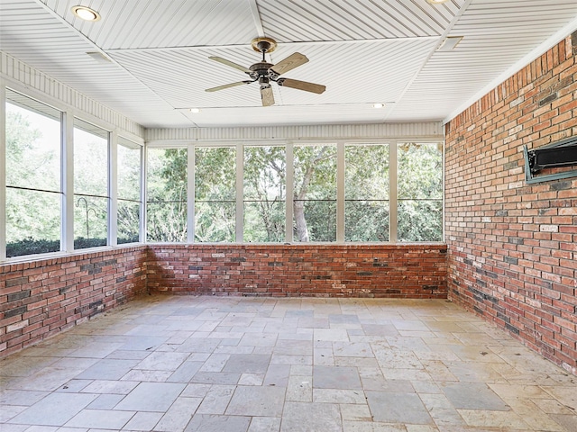 unfurnished sunroom featuring ceiling fan