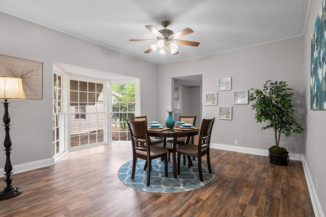 dining room featuring a ceiling fan, wood finished floors, and baseboards
