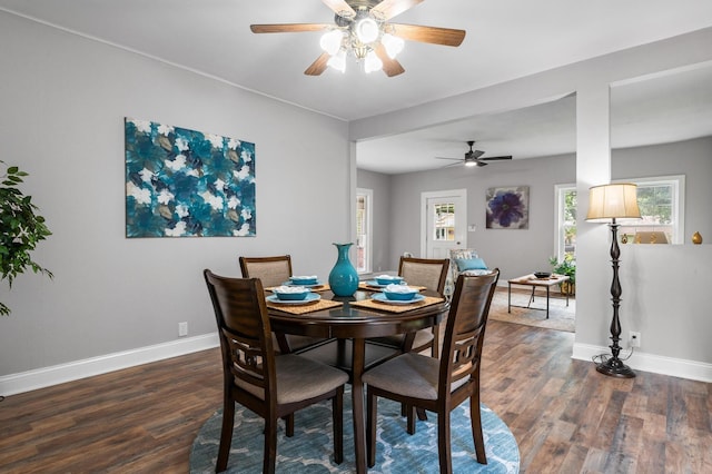 dining area featuring a ceiling fan, dark wood finished floors, and baseboards
