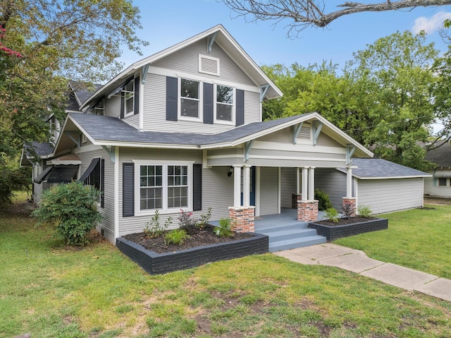 view of front of home with covered porch and a front lawn