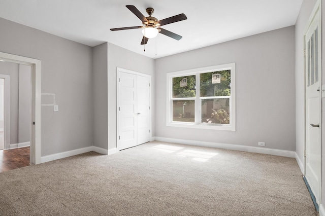 unfurnished bedroom featuring a closet, ceiling fan, carpet floors, and baseboards