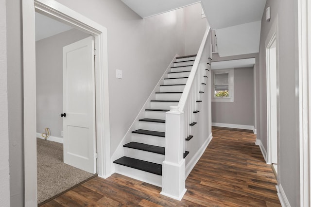 stairs with baseboards and wood finished floors