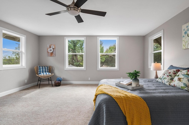 carpeted bedroom featuring ceiling fan and baseboards