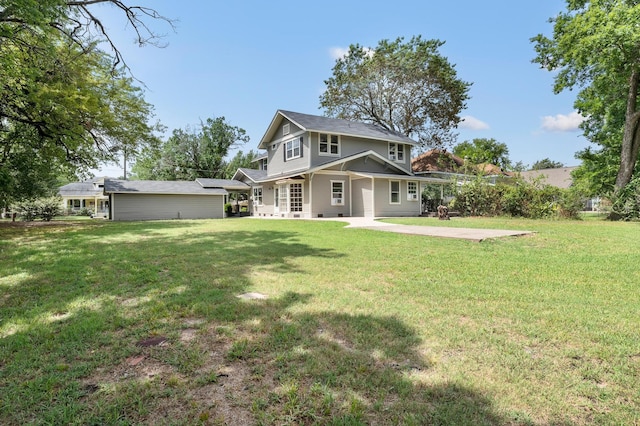 rear view of house with a lawn and a patio area