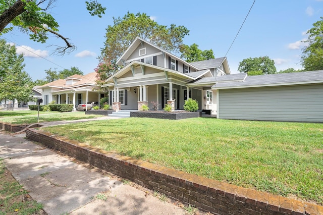 view of front facade featuring covered porch, central AC, and a front yard