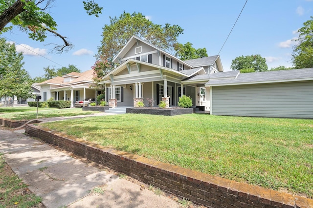 view of front of property featuring covered porch and a front yard