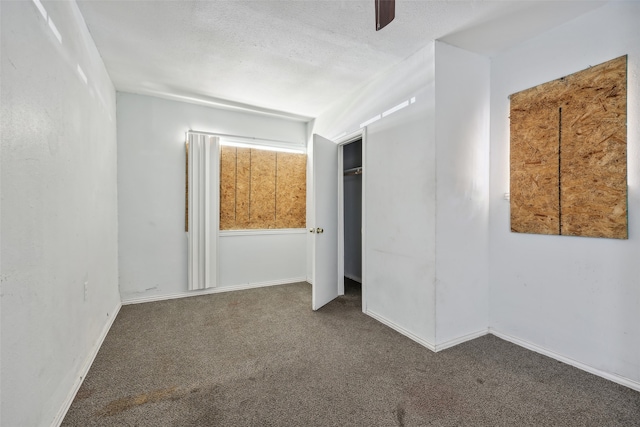 carpeted empty room featuring a textured ceiling and ceiling fan